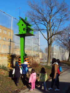 Kids looking at birdhouse